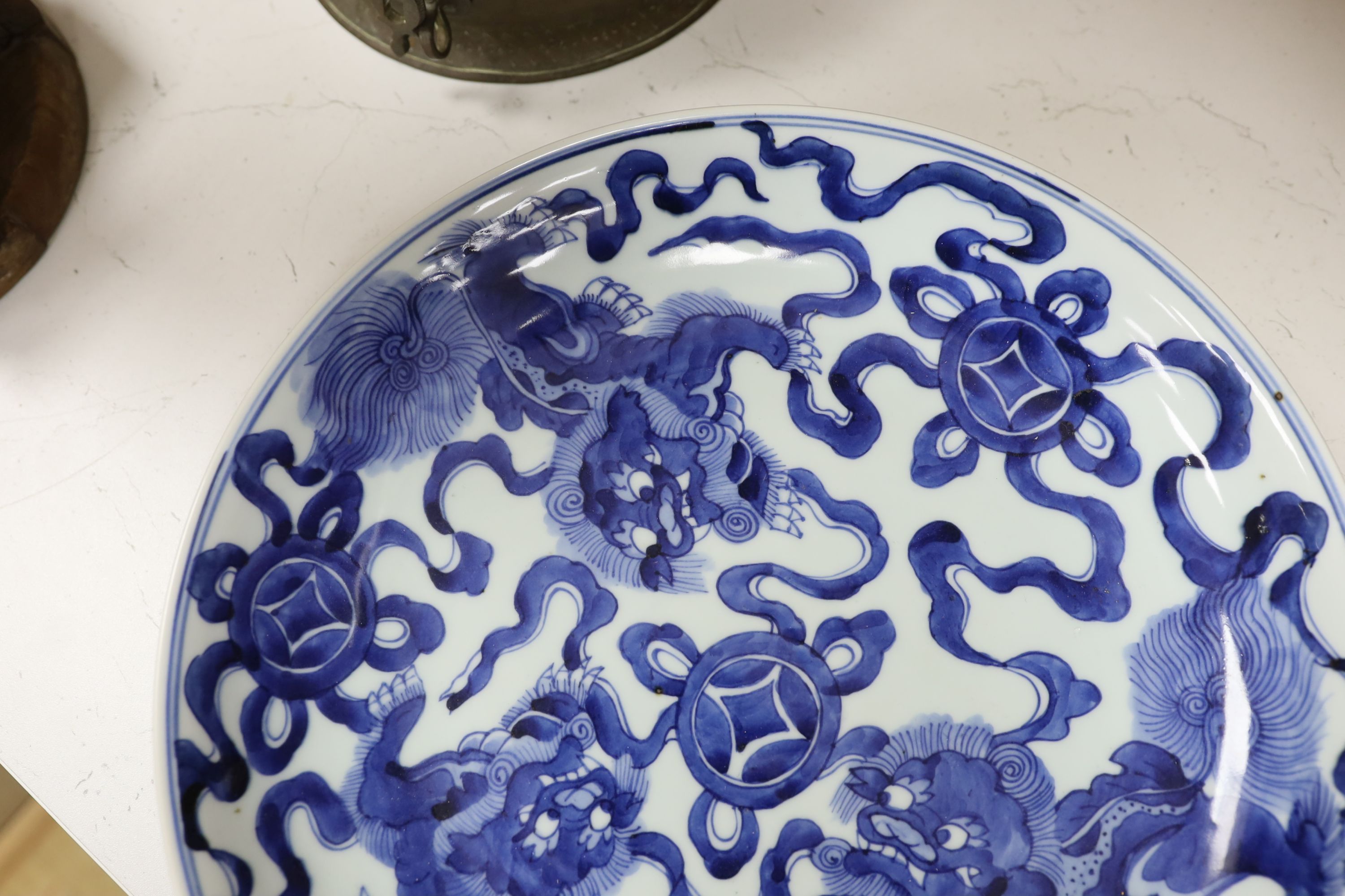 A Chinese blue and white ‘Buddhist lion’ dish, channel moulded foot, 36cm diameter